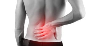 Shirtless man with lower back pain or backache