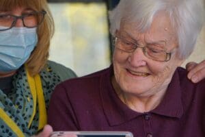 Personal Support Worker helping an individual.