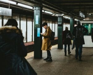 Toronto commuter experiencing tech neck from smartphone use