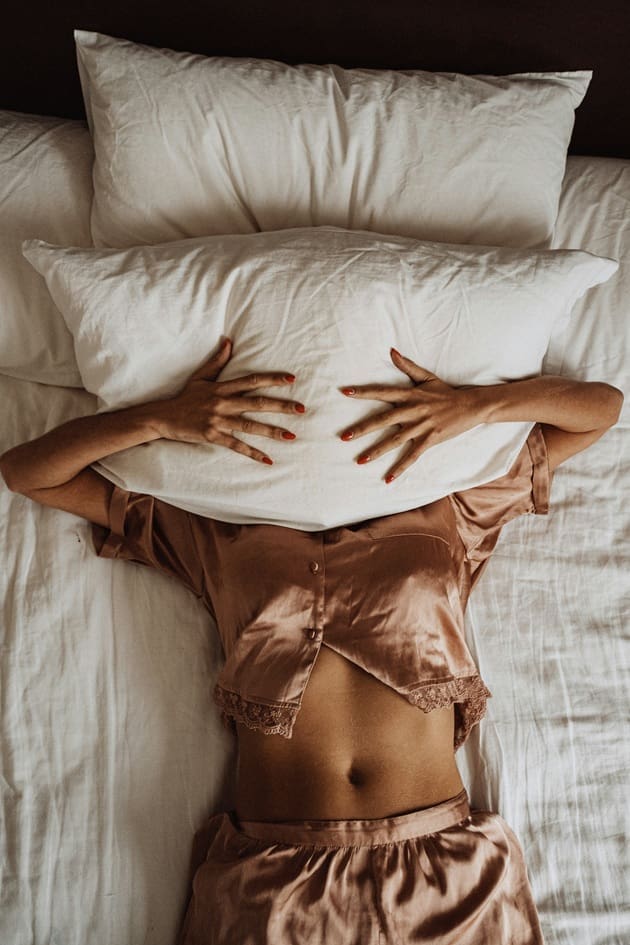 Toronto resident stretching in bed to ease morning stiffness and back pain